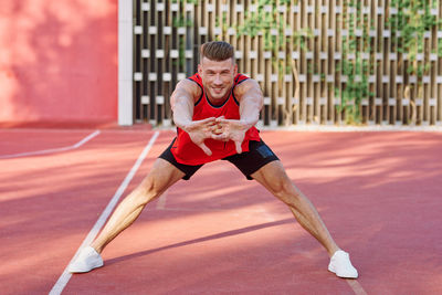 Young woman exercising on court