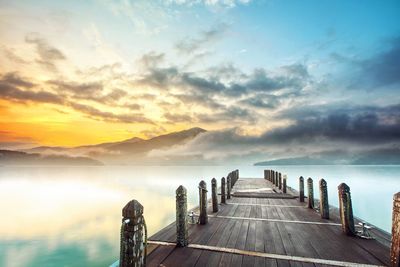 Scenic view of lake against sky during sunset