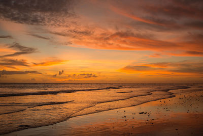 Scenic view of sea against orange sky