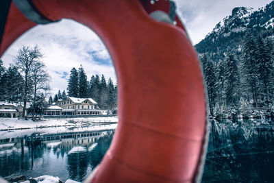 Close-up of lake seen through life belt during winter