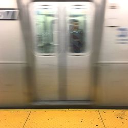 Blurred motion of train at railway station