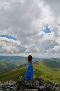 Rear view of woman standing on mountain