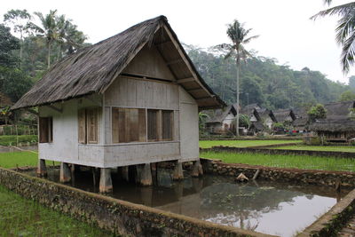 Built structure by trees against sky