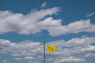 Low angle view of flag against sky