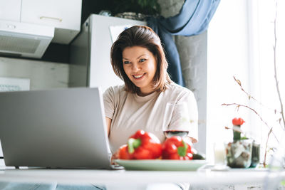 Portrait of young woman using mobile phone