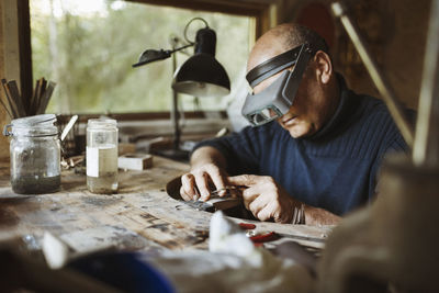 Portrait of man working on table