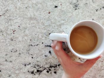 Midsection of person holding coffee cup