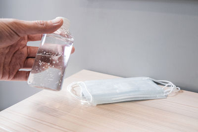 Close-up of hand holding glass of table