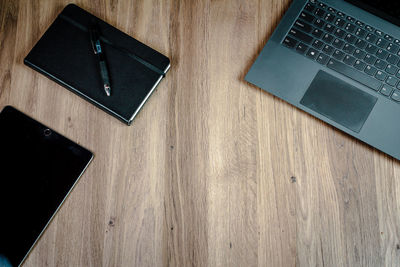 High angle view of laptop and book on table