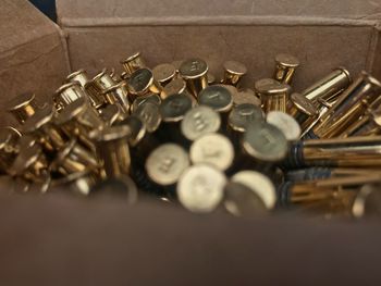 Close-up of gold musical equipment in cardboard box