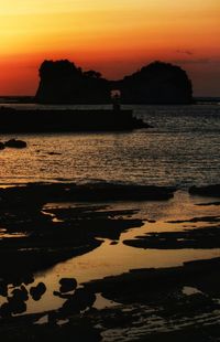 Scenic view of sea against orange sky