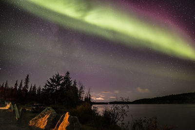 Scenic view of lake against sky at night