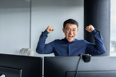 Portrait of businessman using mobile phone in office