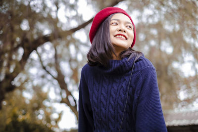 Portrait of a smiling young woman looking away