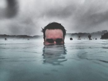 Portrait of man swimming in geyser