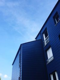 Low angle view of modern building against blue sky