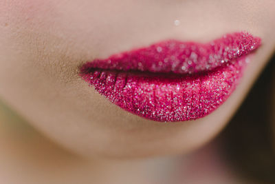 Close-up of woman wearing lipstick with glitter