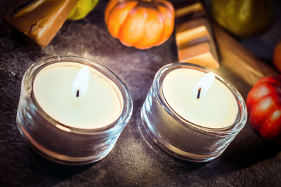 High angle view of tea light candles burning on table