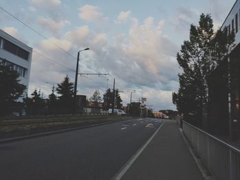 Road by city against sky