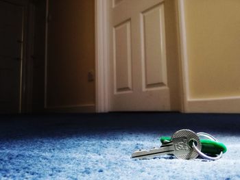 Close-up of open door on floor at home