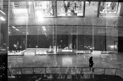 Man walking on illuminated street at night