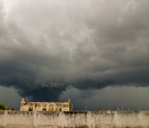 Storm clouds over buildings in city