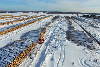 High angle view of snow covered field against sky