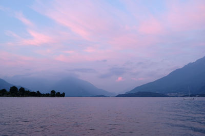 Scenic view of lake against pink romantic sky at sunset