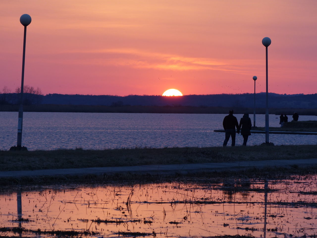 SILHOUETTE MAN ON SEA AGAINST SKY DURING SUNSET