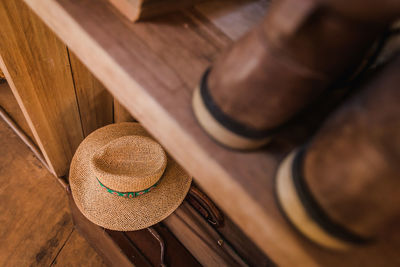 High angle view of hat on wooden shelf
