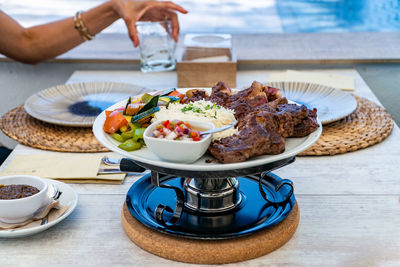 Cropped hand of woman having food on table