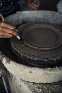 Cropped image of potter working at workshop