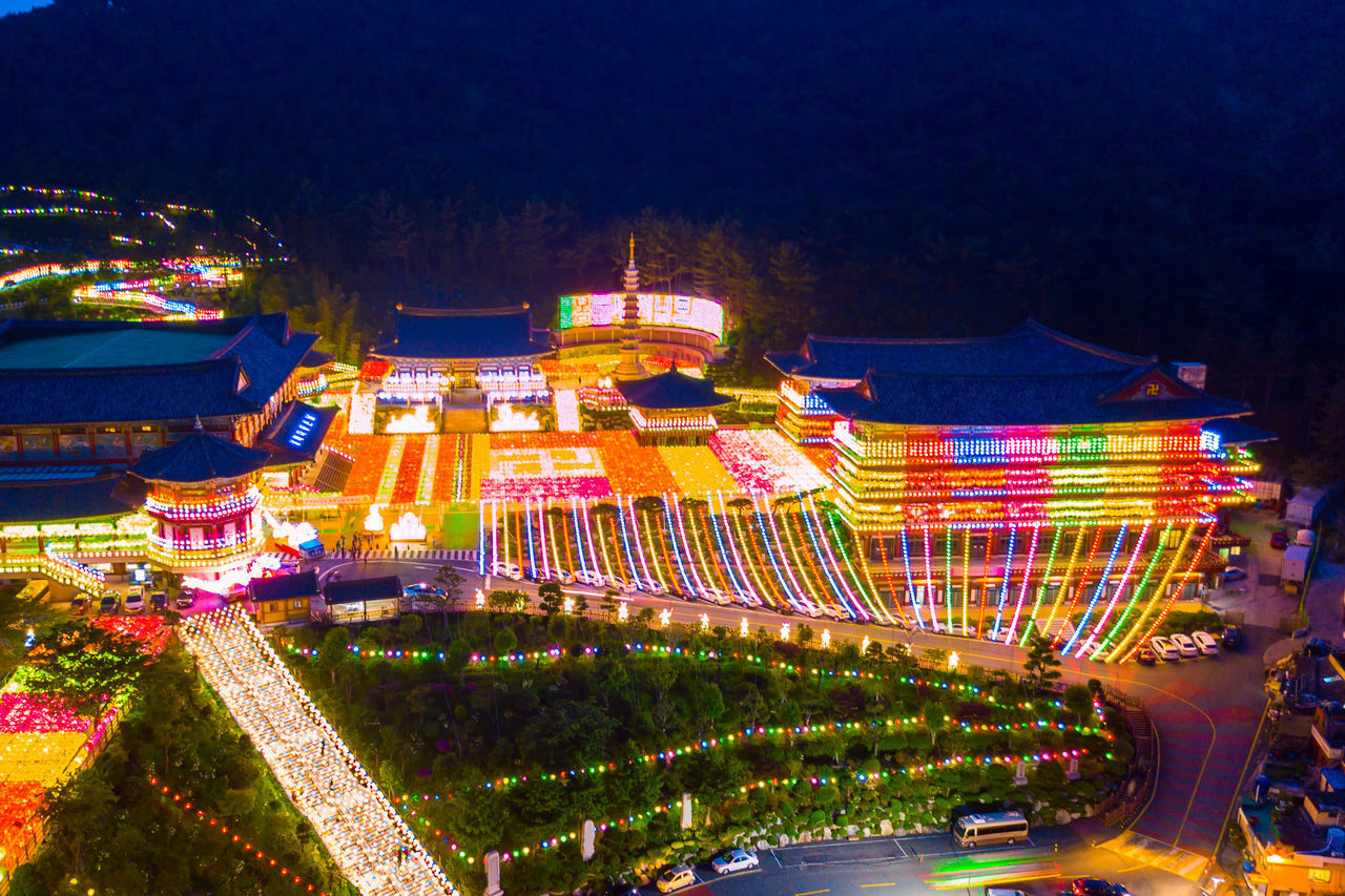 HIGH ANGLE VIEW OF ILLUMINATED FERRIS WHEEL AT NIGHT