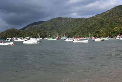 Scenic view of sea and mountains against sky