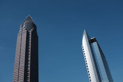 Low angle view of messeturm against blue sky