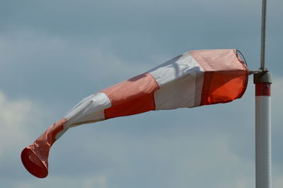 Low angle view of flag against blue sky