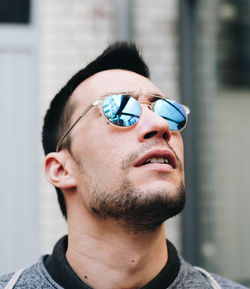 Mid adult man wearing sunglasses while looking away in city