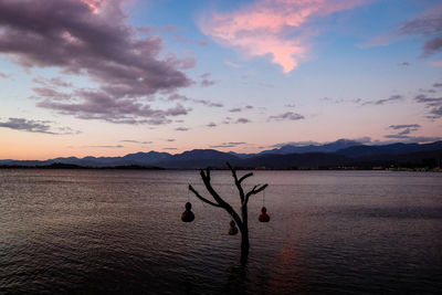 Scenic view of lake against sky at sunset
