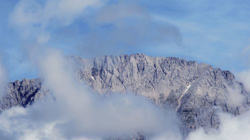 Low angle view of snowcapped mountain against sky