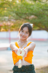 Portrait of young woman standing outdoors