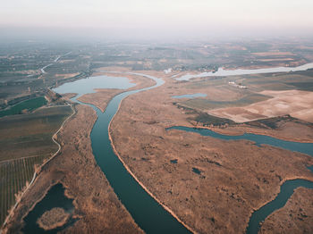 High angle view of river amidst landscape against sky