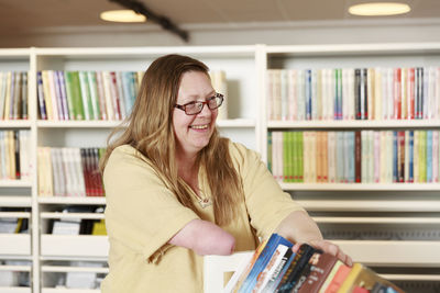 Smiling woman working in library