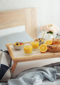 Romantic breakfast with coffee, waffles, orange juice and rose flowers.