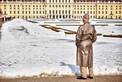 Rear view of statue of man in city