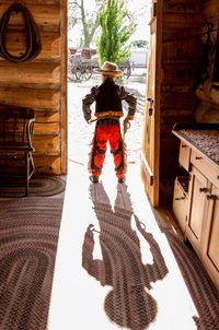 Rear view of man standing on floor