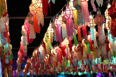 Low angle view of illuminated lanterns hanging at temple