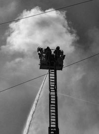 Low angle view of crane against sky