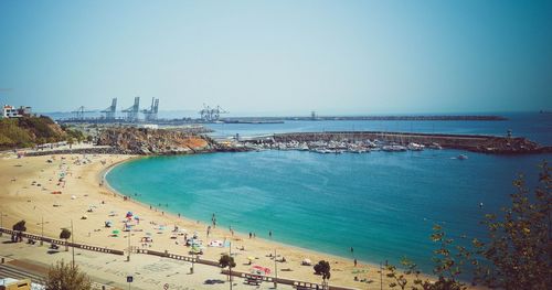 High angle view of people on beach against clear sky
