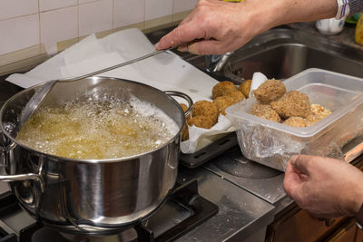 Cropped hands of person preparing food in kitchen at home