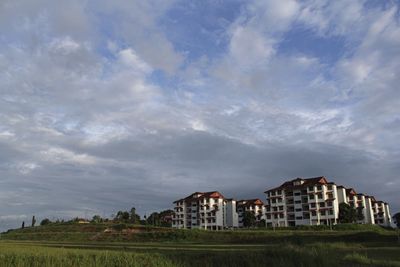 Buildings against cloudy sky